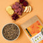FAVLY Petfood Hirsch mit Kartoffel, Rote Bete & Apfel, serviert mit rohem Fleisch, Rote-Bete-Stückchen und Apfelscheiben.